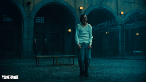 Man In White Shirt In Dark Room With Jokermovie GIF
