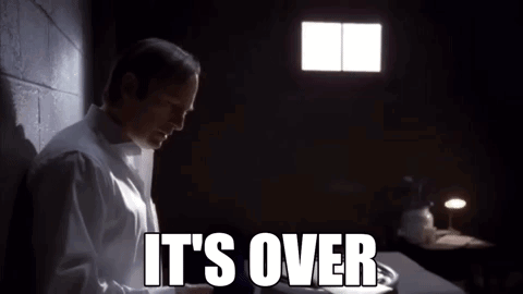 A Man In A White Shirt Is Standing In A Dark Room With The Words It 'S Over Written On The Screen . GIF