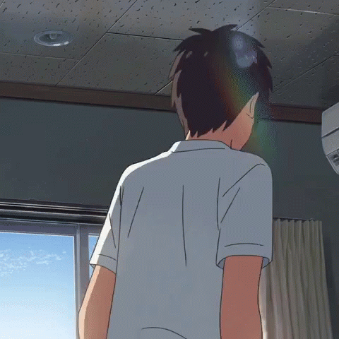 A Man In A White Shirt Is Standing In A Room GIF