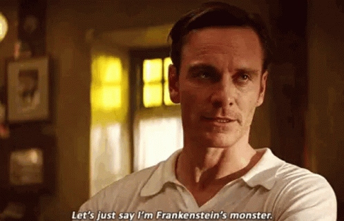 A Man In A White Shirt Is Standing In A Room With His Arms Crossed . GIF