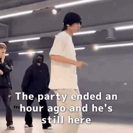 A Man In A White Shirt Is Standing In A Room With Other People . GIF