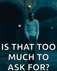 Man In White Shirt In Front Of Building GIF