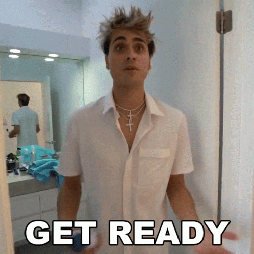 A Man In A White Shirt Is Standing In Front Of A Door With The Word Get Ready Written On It GIF