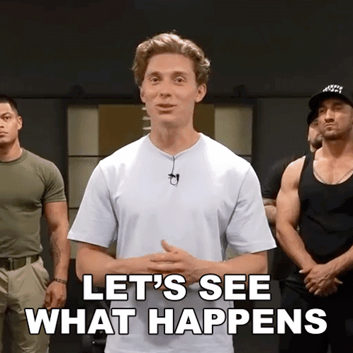 A Man In A White Shirt Is Standing In Front Of A Group Of Men And Says Let 'S See What Happens GIF
