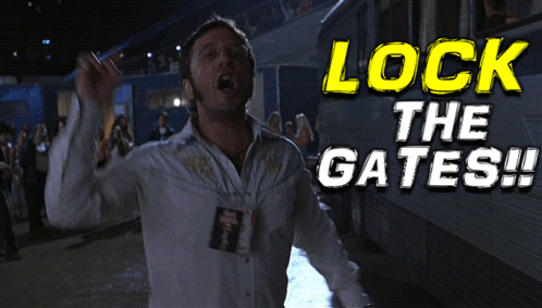 A Man In A White Shirt Is Standing In Front Of A Sign That Says " Lock The Gates " GIF