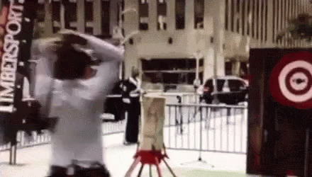 A Man In A White Shirt Is Standing In Front Of A Target Sign GIF