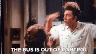 A Man In A White Shirt Is Standing Next To Another Man In A Kitchen And Says The Bus Is Out Of Control . GIF