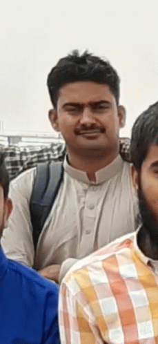 A Man In A White Shirt Is Standing Next To Another Man In A Plaid Shirt GIF