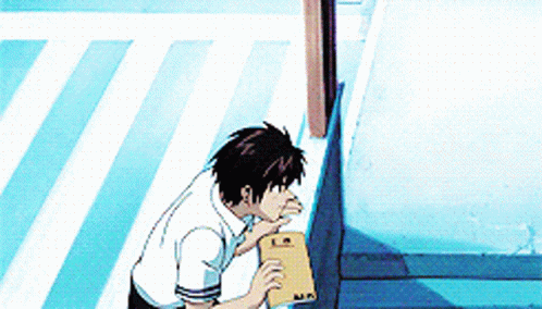 A Man In A White Shirt Is Standing On A Sidewalk Holding A Piece Of Paper With The Letter M On It .. GIF