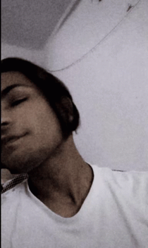 A Man In A White Shirt Is Taking A Picture Of Himself GIF