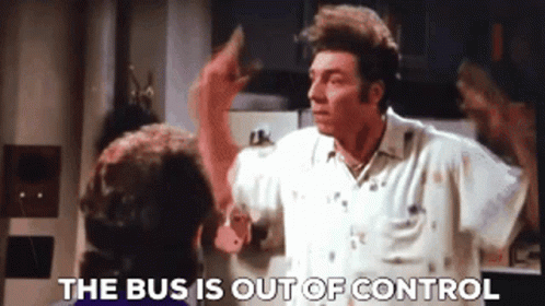 A Man In A White Shirt Is Talking To Another Man In A Kitchen And The Words The Bus Is Out Of Control Are Visible . GIF