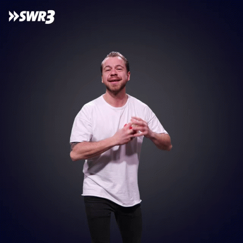 A Man In A White Shirt Is Throwing Food In The Air With Swr3 In The Corner GIF
