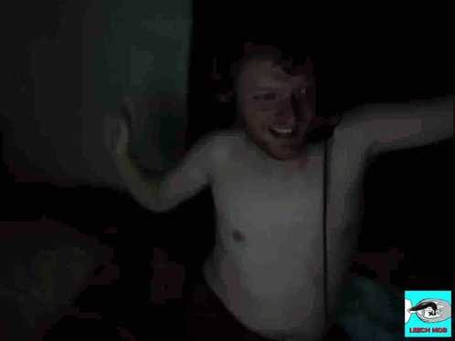 A Man In A White Shirt Is Waving His Hand In The Dark With The Words Peak Male Form Below Him GIF