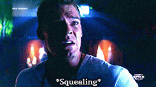 A Man In A White Shirt Says " Squealing " On The Screen GIF