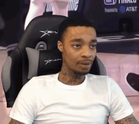 A Man In A White Shirt Sits In A Gaming Chair GIF