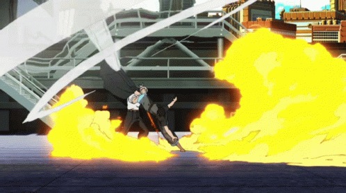 A Man In A White Shirt Stands In Front Of A Large Fire GIF