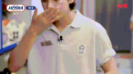 A Man In A White Shirt With A Microphone On His Neck Is Covering His Mouth . GIF