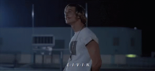 a man in a white shirt with a necklace around his neck says l-i-v-i-n