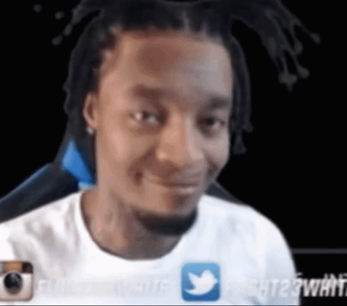 A Man In A White Shirt With A Twitter Icon On It GIF