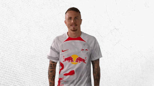 A Man In A White Shirt With Red Bulls On It GIF