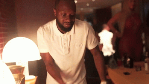 A Man In A White Shirt With The Letter O On It GIF