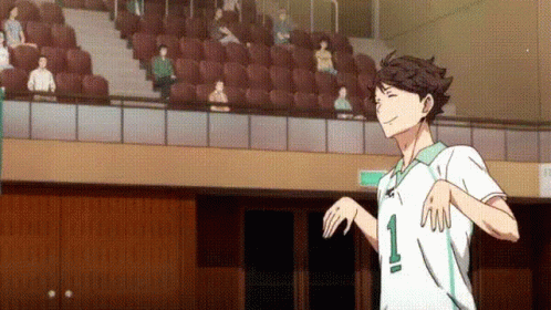 A Man In A White Shirt With The Number 1 On It Is Standing In Front Of A Crowd Of People In A Stadium . GIF