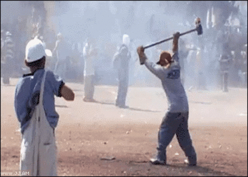 A Man In A White Shirt With The Word Police On The Back Is Holding A Hammer GIF
