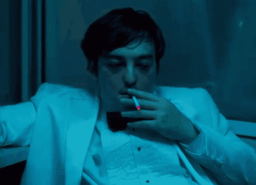 A Man In A White Suit And Black Bow Tie GIF