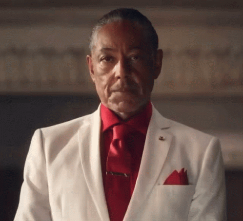 A Man In A White Suit And Red Tie Has A Pocket Square In His Pocket GIF