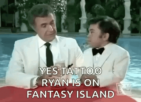 A Man In A White Suit And Tie Is Sitting Next To A Boy In A Tuxedo . GIF