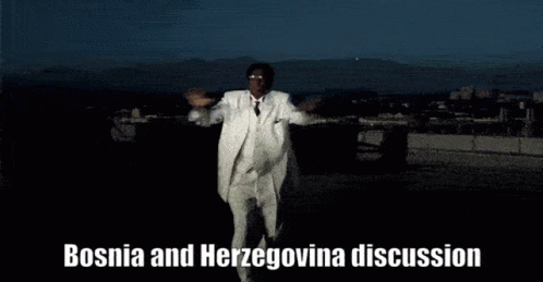 A Man In A White Suit Is Dancing With The Words Bosnia And Herzegovina Discussion Behind Him GIF