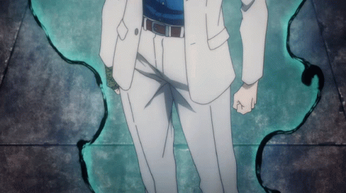 A Man In A White Suit Is Standing In Front Of A Green Wall GIF