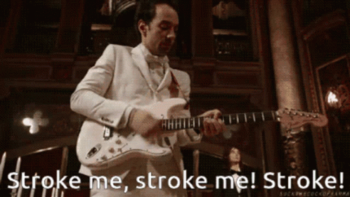 A Man In A White Suit Playing A Guitar With The Words Stroke Me Stroke Me Stroke GIF