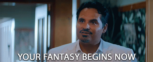 A Man In A White Suit Says " Your Fantasy Begins Now " In Front Of Him GIF