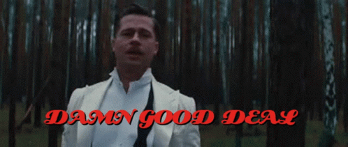 A Man In A White Suit Stands In A Forest With The Words Damn Good Deal GIF