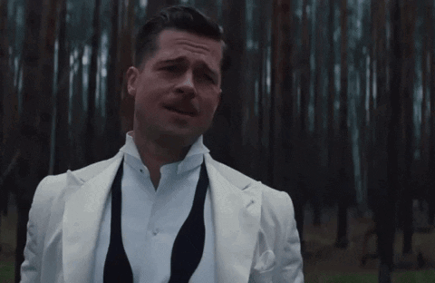 A Man In A White Suit Stands In Front Of A Forest With The Words To Si Nemyslim Written Below Him GIF