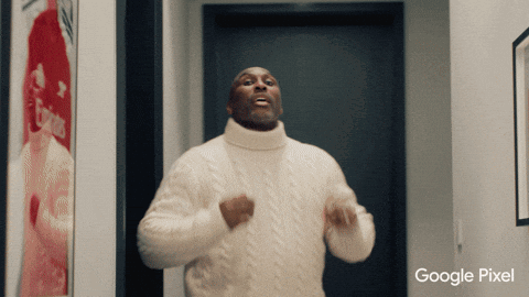 A Man In A White Sweater Is Dancing In Front Of A Google Pixel Ad GIF