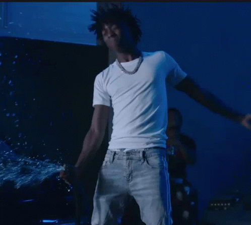 A Man In A White T-Shirt And Jeans Is Dancing GIF