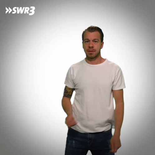A Man In A White T-Shirt Is Standing In Front Of A White Background With Swr3 Written On It GIF