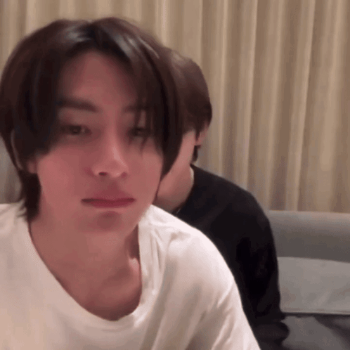 Man In White T-Shirt Looking At Camera GIF