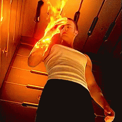 A Man In A White Tank Top And Black Shorts Is Holding A Fireball In His Hand . GIF