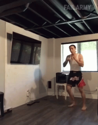 A Man In A White Tank Top And Shorts With The Word Fail Army On The Bottom Right GIF