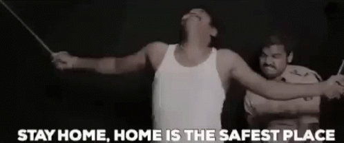 A Man In A White Tank Top Is Being Tortured By A Police Officer With A Stick . GIF