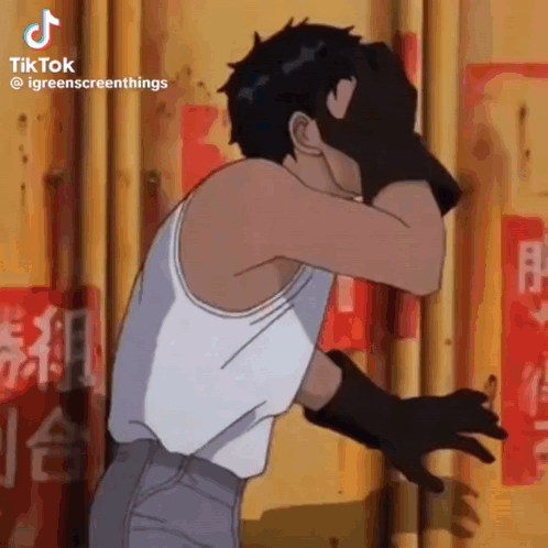A Man In A White Tank Top Is Covering His Face With His Hand . GIF