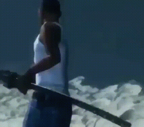 A Man In A White Tank Top Is Holding A Sword In His Hand GIF