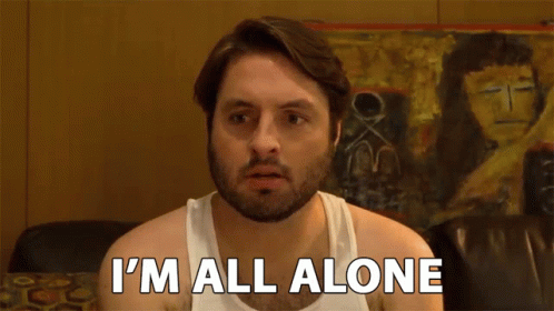 A Man In A White Tank Top Is Saying I 'M All Alone GIF