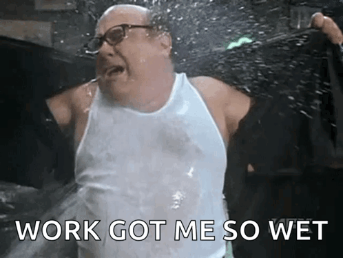 A Man In A White Tank Top Is Splashing Water On Himself . GIF