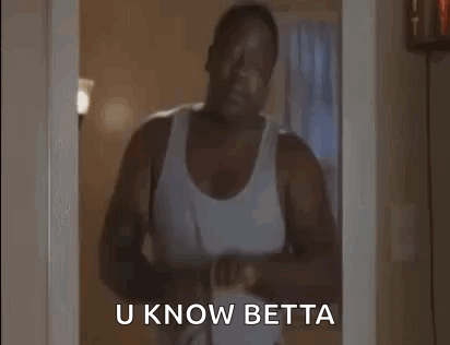 A Man In A White Tank Top Is Standing In A Doorway Holding A Belt And Says `` U Know Betta '' . GIF