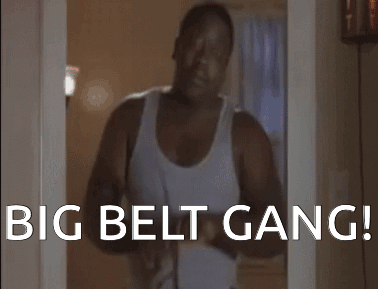 A Man In A White Tank Top Is Standing In A Doorway With The Words " Big Belt Gang " On The Bottom GIF