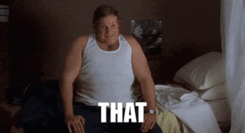 A Man In A White Tank Top Sits On A Bed With The Word That Written Below Him GIF